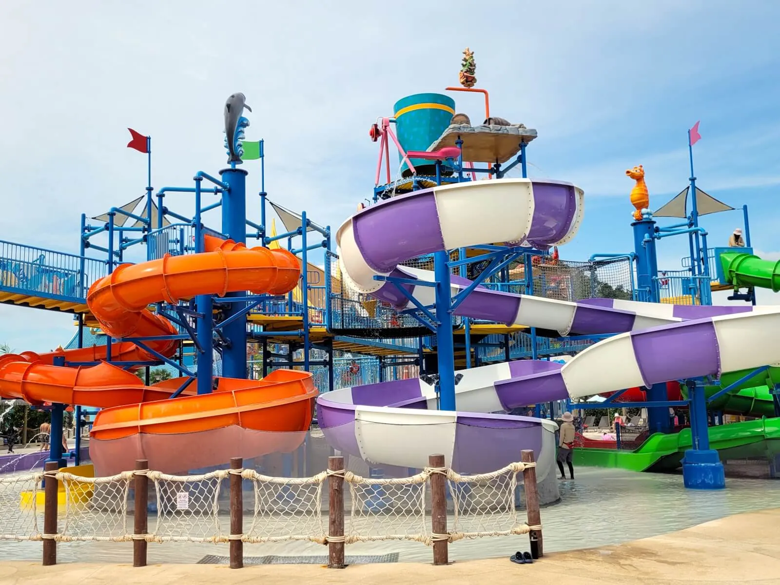 Kids' play tower with spiral slides and a giant tipping bucket