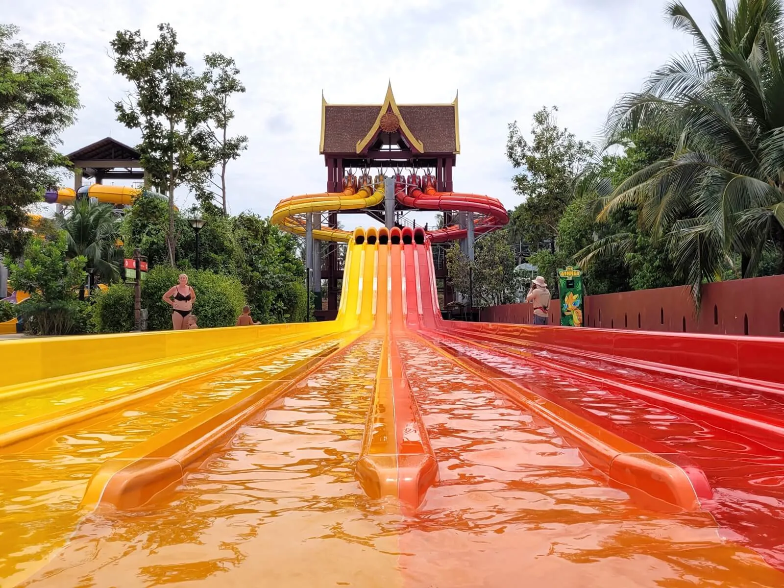 The six coloured lanes of Racing Nagas below a Thai-style tower